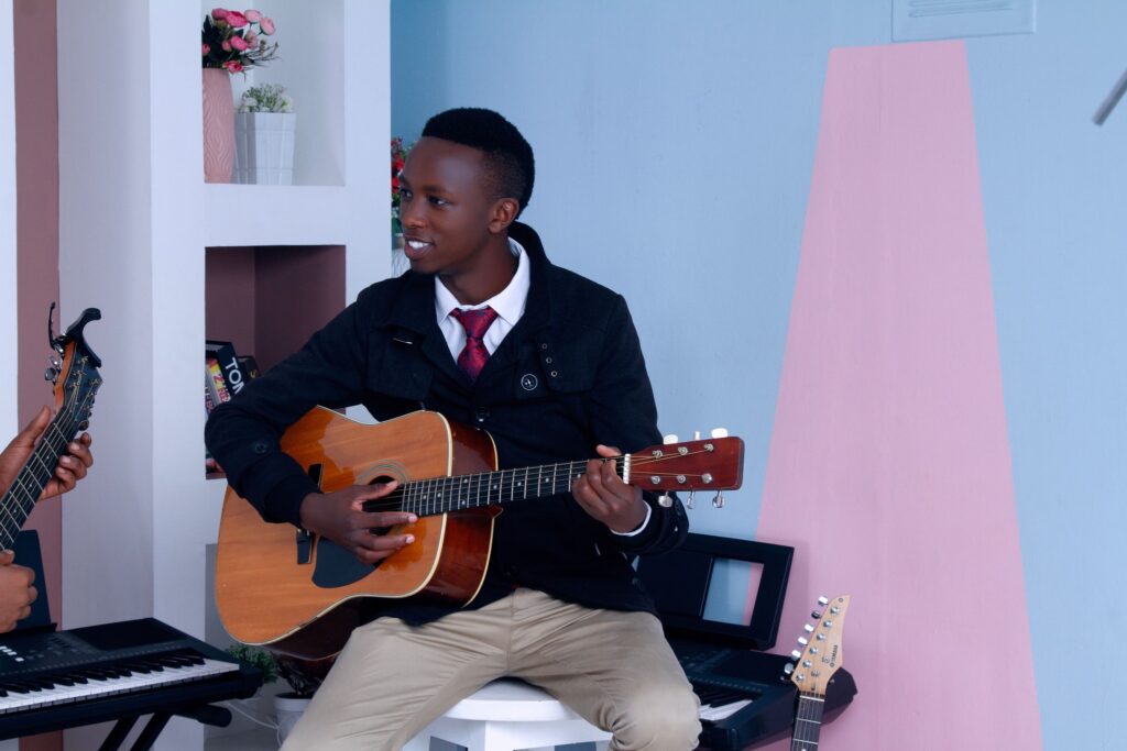 A man taking acoustic guitar lessons